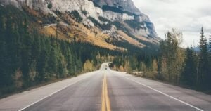 Scenic mountain highway road trip in India surrounded by forests and hills