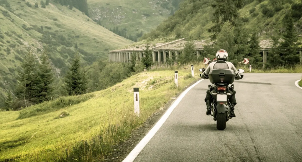 Motorbike tour rider on scenic highway during monthly motorcycle escape