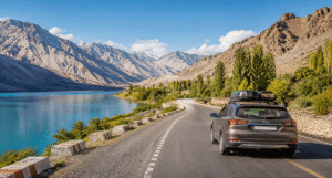 Road trip vehicle on an organized self-drive expedition traveling through a scenic mountain landscape.